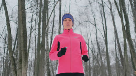 Woman-Running-at-snowly-winter-under-sunlight.